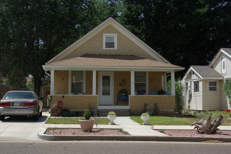 Streetside view of front of an older home with a front porch